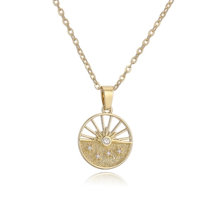 Golden geometric necklace with sunrise and hills pendant featuring sparkling gemstones