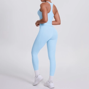 Detail view of light blue ribbed sports bra and high-waisted yoga leggings side pockets