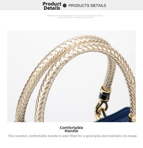 Detail of navy patent leather handbag showing braided gold handle and metal hook