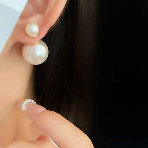 Close-up of elegant double white pearl earrings shown on ear for a minimalist look