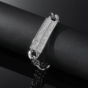 Detail of silver Cuban chain bracelet with iced-out rectangular plaque on leather display