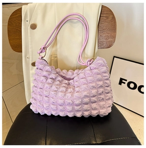 Close-up of lavender bubble textured shoulder bag with metallic ring handle detail