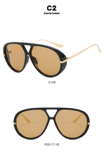 Detail view showing black thick frames and golden metal temples of the aviator sunglasses