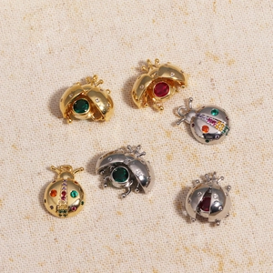 3D ladybug insect pendants in gold and silver plating with colorful gemstone inlay details