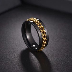 Close-up of black titanium steel ring featuring a rotating gold chain inlay design