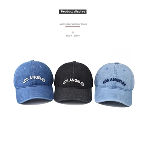Three washed denim baseball caps with Los Angeles embroidery in blue and black colors
