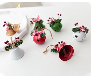 Detailed view of colorful Christmas metal bells with bows and pine needles decorations