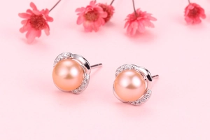 Detailed macro view of S925 silver crown earrings with natural champagne pearls and zircons