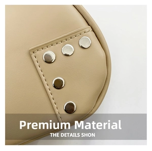 Close-up of beige leather bag texture with silver rivets and neat stitching details