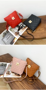 Detailed view of quilted bucket bags in red, black, pink and brown with gold twist locks
