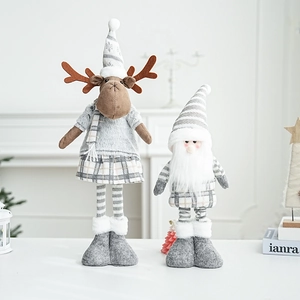 Detail of Nordic grey plush reindeer and Santa gnome dolls with festive plaid patterns