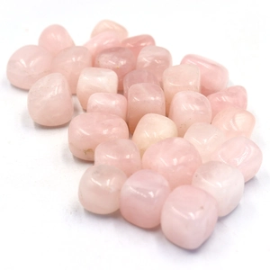 Close-up of polished natural rose quartz stones with translucent pink texture