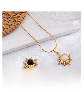 Detail of sun flower pendants with natural stones on delicate gold snake chains