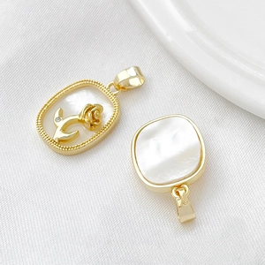 Detail of 18k gold plated white mother of pearl pendants with rose pattern and square shape