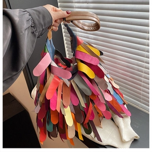 Detailed shot of vibrant colorful leather fringe layers on a large hobo shoulder bag