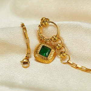 Detailed view of vintage gold chain bracelet featuring square emerald green zircon gemstone