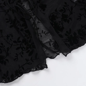 Macro detail of black mesh chiffon blouse with floral flocking and drawstring tie