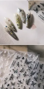 Macro detail of 3D embossed butterfly nail art stickers with elegant Chinese calligraphy