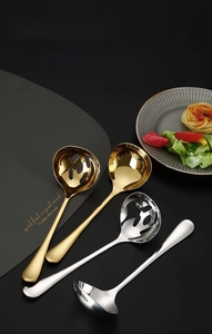 Detailed view of gold and silver 304 stainless steel soup ladles and slotted spoons