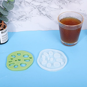 Detail of lotus root silicone mold and green resin coaster on a blue surface