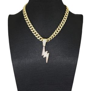 Hip hop gold Cuban chain with iced-out lightning bolt pendant on a black model bust