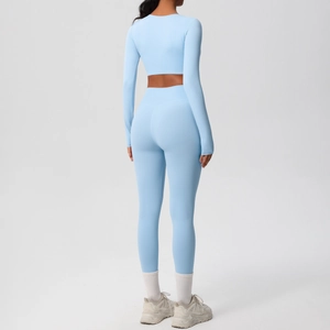 Rear view of a light blue long-sleeved crop top and high-waisted leggings yoga set