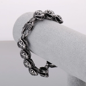 Macro view of Punk snake head links on heavy silver stainless steel bracelet for men