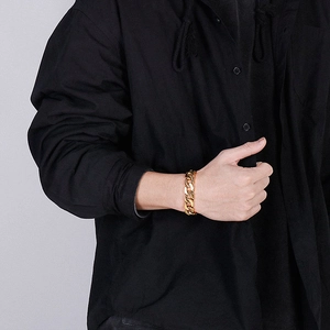 Close-up of a men's 18K gold-plated Cuban link bracelet worn on a wrist for fashion