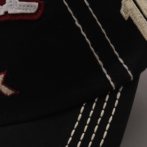 Macro shot of cotton baseball cap showing contrast stitching and SPARK letter embroidery