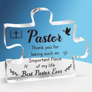 Macro shot of puzzle-shaped clear acrylic ornament with printed inspirational pastor quote