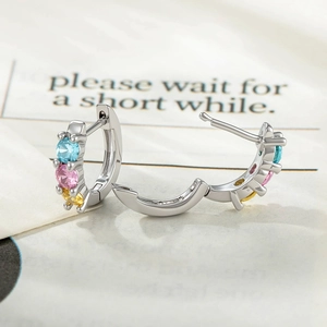 Silver hoop earrings with blue pink and yellow zircon stones shown open and closed