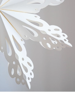Detailed laser-cut hollow pattern and folding structure of a white paper snowflake star