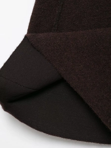 Detailed macro view of dark coffee brown knit fabric with thick texture and fuzzy fibers