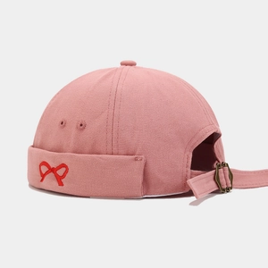 Pink cotton canvas docker cap with red bow embroidery and adjustable metal buckle