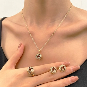 Detailed view of a gold-tone twisted rope jewelry set featuring necklace, ring, and earrings
