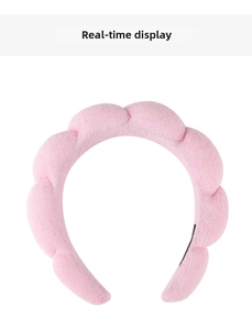 Detail of pink sponge headband featuring soft terry cloth texture for skincare