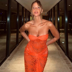 Detailed close-up of orange lace dress featuring sexy mesh splicing and hollow out design