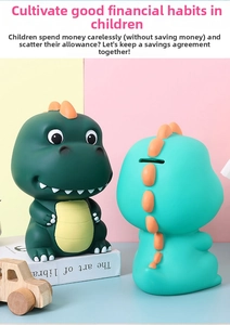 Close-up of the coin slot on a matte green cartoon dinosaur piggy bank for kids
