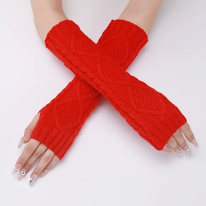 Close-up of red cable knit arm warmers showing the soft diamond pattern texture