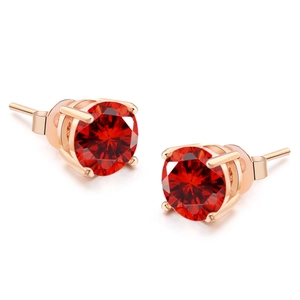 Detailed view of round-cut ruby red zircon earrings with four-prong rose gold setting