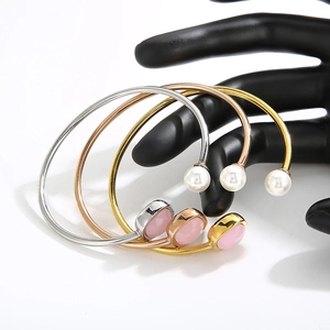 Set of three stainless steel open bracelets with pearls and pink gems in multiple colors