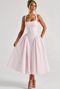 Detail view of the side ruffled puff skirt hem on a pink plaid gingham dress