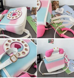 Detail of creative telephone-shaped crossbody bag with vintage dial and gradient color