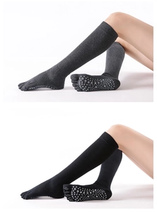 Close-up of anti-slip grips on cotton blend five-finger yoga socks in grey and black