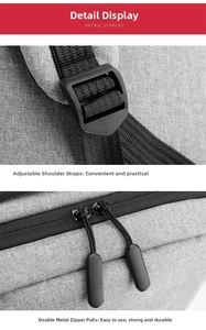 Detail view of smooth metal dual zippers and adjustable shoulder strap buckle on grey backpack