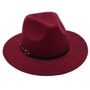 Detail of burgundy fedora hat with black leather strap and gold metal buckle trim