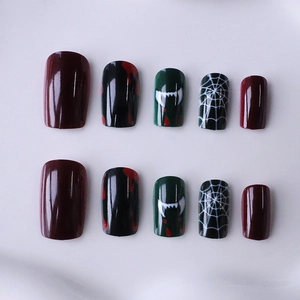 Halloween press-on nails with spider web and blood vampire fang designs in dark red and black