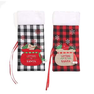 Christmas plaid wine bottle covers with white plush trim and Santa embroidery