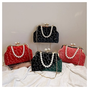 Detail of vintage velvet pearl handbags in four colors with gold chains and floral textures