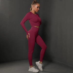 Detail view of burgundy seamless yoga set with thumbhole sleeves and high waist leggings